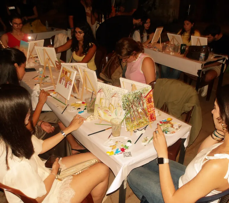 The full room mid-evening, every easel occupied