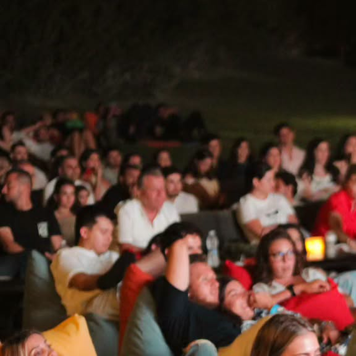 A crowd reclining on colorful beanbags at a previous Taht L Amar screening.
