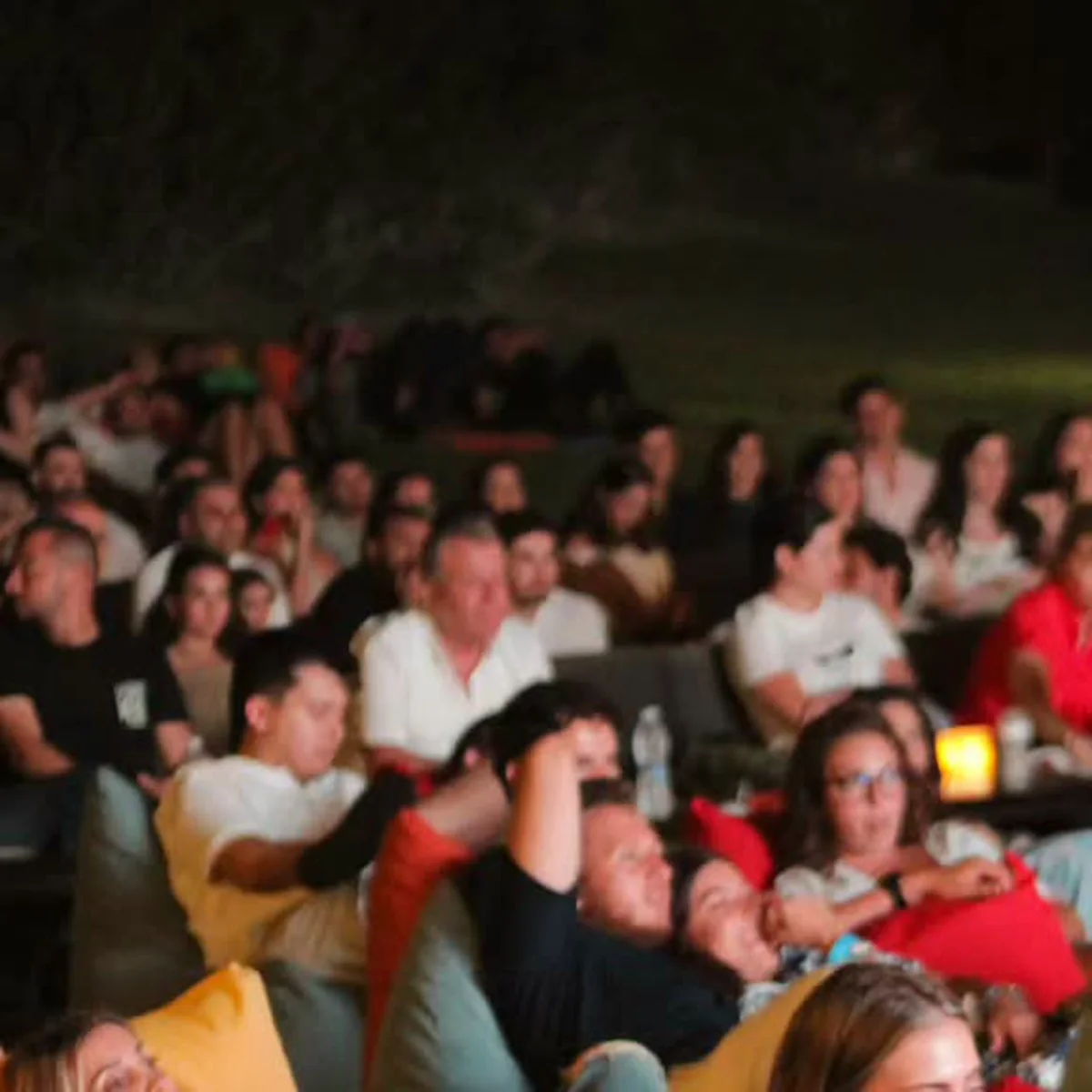 A crowd reclining on colorful beanbags at a previous Taht L Amar screening.